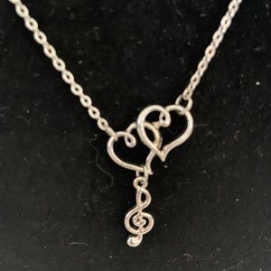 Lovely silver-tone necklace with treble clef and two hearts for music lover